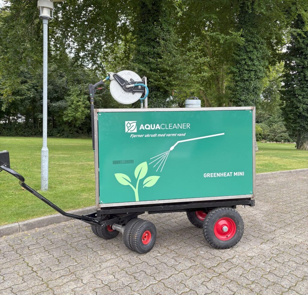 Compact Greenheat Mini machine from Aqua Cleaner for non-toxic weed control with 105-degree hot water on tiled areas.
