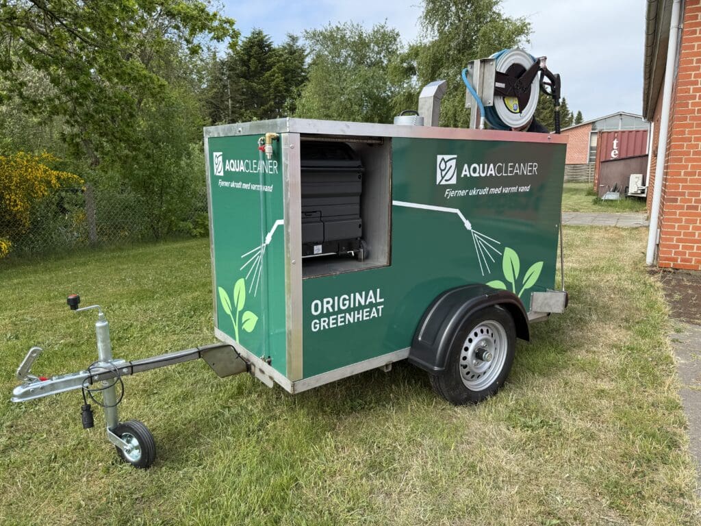 A green Aqua Cleaner Greenheat trailer for environmentally friendly weed control using 105-degree hot water without the use of pesticides.
